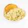 Bowl of Creamy Pesto Chicken Pasta topped with Parmesan cheese and served with garlic bread