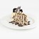 Slice of Marbled Swirled Cheesecake drizzled with chocolate sauce and topped with whipped cream and mini brownies