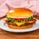 A cheeseburger with tomato and lettuce
