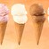 4 ice cream cones with different flavors including strawberry, vanilla, chocolate and cookies and cream