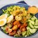 A Shrimp Louie Salad, featuring shrimp, tomatoes, cucumbers and hard boiled eggs