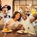 Minnie interacts with a family as they dine at Topolino’s Terrace, Flavors of the Riviera