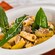 A bowl of rigatoni garnished with fresh herbs and cheese
