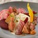 A plate with burrata cheese and an assortment of vegetables