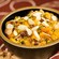 A bowl of squash with raisins and sliced almonds
