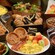 Several platters of breakfast foods, including Mickey waffles, bacon, eggs, pastries and fresh fruit