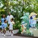 A family walking outside past signage showing Bingo and Bluey