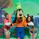 Two young adult Guests posing for a photo with Goofy