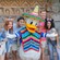 Four young adult Guests posing with Donald Duck wearing a poncho and sombrero