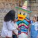 A family of 4 greeting Donald Duck wearing a poncho and sombrero
