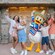 A family of 4 posing with Donald Duck wearing a poncho and sombrero