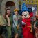 A family of 4 posing for a photo with Sorcerer´s Apprentice Mickey Mouse in Meet Disney Stars at Red Carpet Dreams