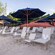 Rows of lounge chairs with rolled towels beneath umbrellas on a beach at Disney's Typhoon Lagoon