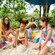 Kids build sandcastles on the beach at Disney's Blizzard Beach water park as parents relax nearby