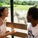 A man and a woman in a tram with a zebra in the background at Harambe Wildlife Preserve
