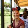 A woman posing in a tram as animals graze in the background at Harambe Wildlife Preserve