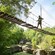 A person crosses a rope bridge above the Safi River Valley in Disney's Animal Kingdom theme park