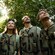 4 people in vests look up at the forest canopy at Disney's Animal Kingdom theme park