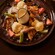 French toast topped with scoops of vanilla ice cream, blueberries, strawberries and kiwi