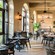A sunlit dining room with tables set for service in Ravello at the Four Seasons Resort Orlando