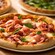 Three pizzas including one with prosciutto, fresh mozzarella and basil