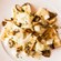 Ravioli with sautéed mushrooms, cream sauce and shaved cheese on a plate