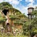 Guest riding Tiana's Bayou Adventure, featuring foliage and a water tower
