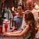 A young girl assembling a droid at a workbench inside Droid Depot at Star Wars: Galaxy's Edge  