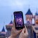 A Guest’s mobile phone captures an image of Sleeping Beauty Castle with added augmented reality fireworks