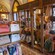 A wooden shelf and hanger inside of Il Bel Cristallo at Epcot displaying handbags