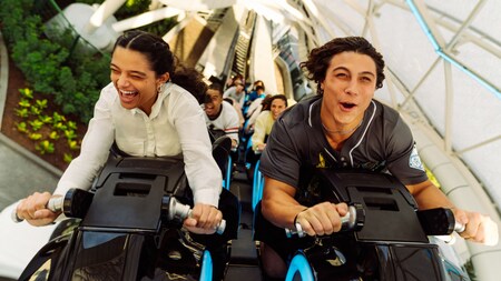 Guests with mouths open reacting in excitement as they ride Tron Lightcycle Run