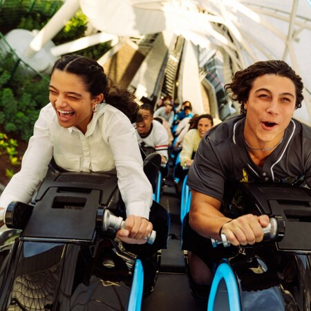 Guests with mouths open reacting in excitement as they ride Tron Lightcycle Run