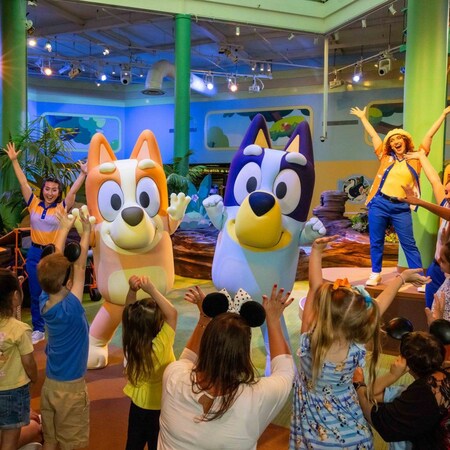 Bingo, Bluey and Disney Cast Members dancing with a group of kids