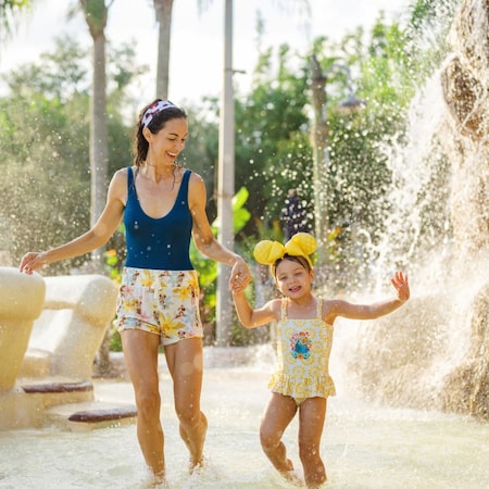 A mother and her young daughter playing at Ketchakiddee Creek at Disney’s Typhoon Lagoon water park