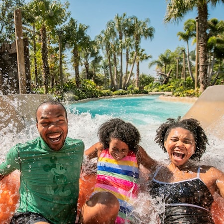 A family laughing while riding Miss Adventure Falls