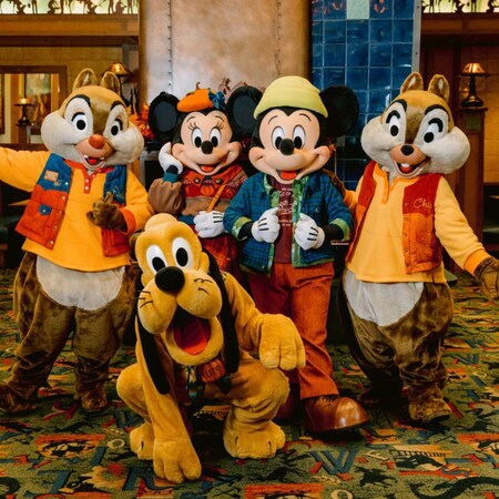 Chip ‘n’ Dale, Mickey Mouse, Minnie Mouse and Pluto posing in fall clothing at Storytellers Cafe