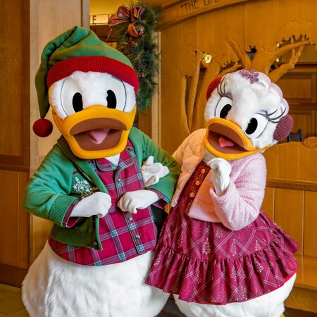 Donald Duck and Daisy Duck posing in holiday pajamas at Storytellers Cafe