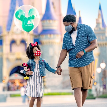 Father and daughter in front of Cinderella's Castle