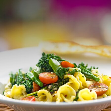 A broccolini dish with tomatoes and other vegetables