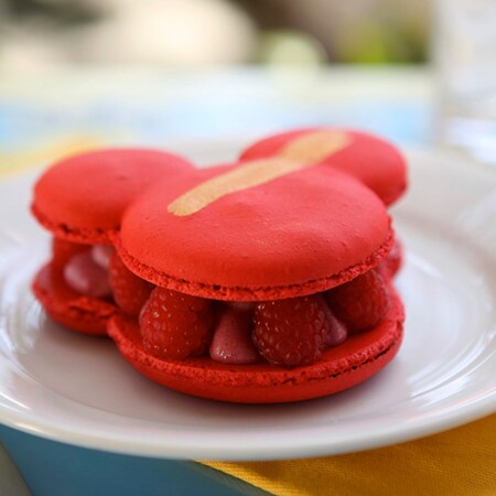 Mickey shaped raspberry macaron on a plate