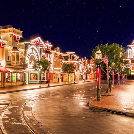 A sea of stars filling the sky as vibrant lights illuminate Main Street, U.S.A. at Disneyland Park