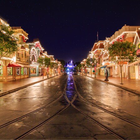 Vibrant lights line rooftops and marques at Main Street, U.S.A. on the way to Sleeping Beauty Castle