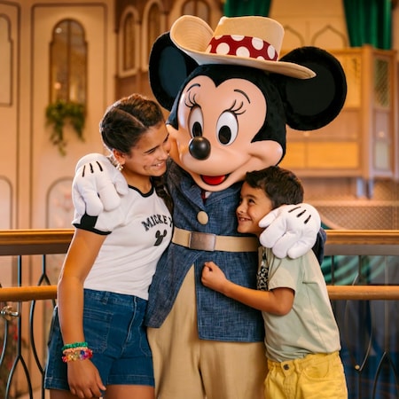 Minnie Mouse hugging a boy and a girl