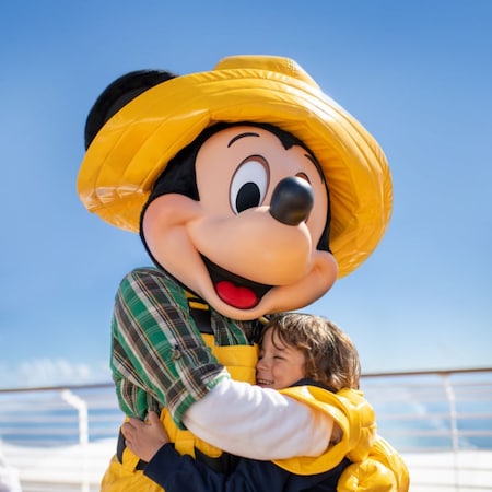 Fisherman Mickey Mouse hugging a small child