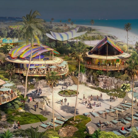 A tropical beach setting with splashing fountains, dining and recreational spaces, and several pavilions