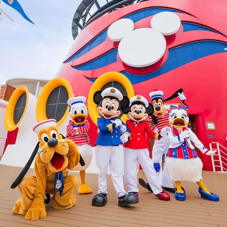 Captains Mickey Mouse and Minnie Mouse, Sailors Donald and Daisy Duck, Goofy and Pluto near a Disney Cruise Line ship funnel