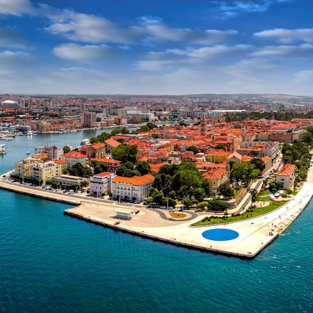 Zadar Old Town peninsula highlighted by the seafront walkway known as Riva promenade, surrounded on 3 sides by the Adriatic Sea