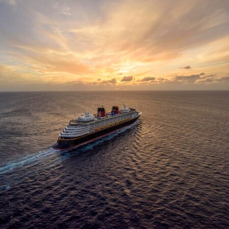 A Disney cruise ship sailing into the sunset
