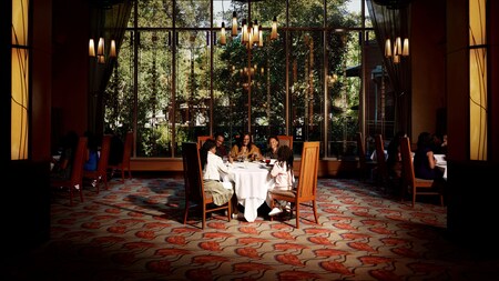 A family of 5 sitting at a dining table in the Napa Rose restaurant at Disney's Grand Californian Hotel & Spa