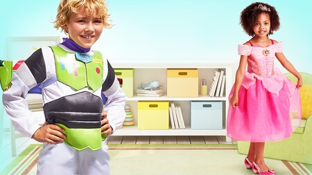 A young boy wearing a Buzz Lightyear costume and a young girl wearing a Princess Aurora costume
